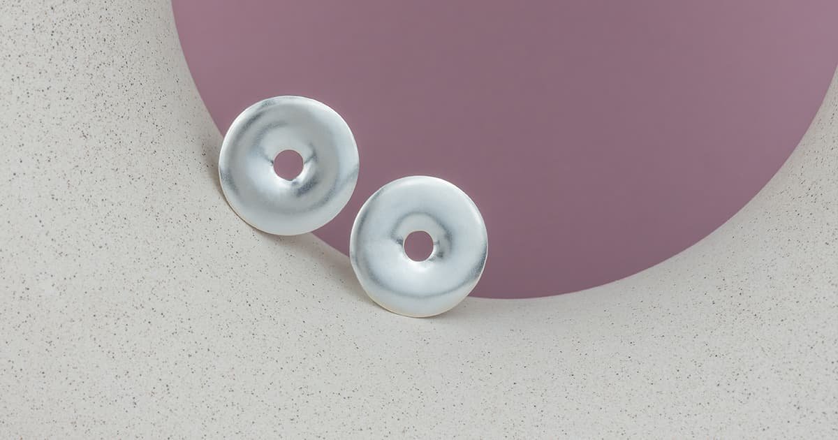 Silver earrings on a semicircle